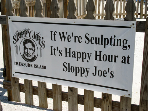 sloppy joes sand sculpture happy hour sign