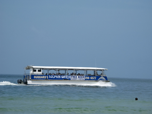 sunshine beach on treasure island fl south of john's pass is a great place to watch the dolphin boat