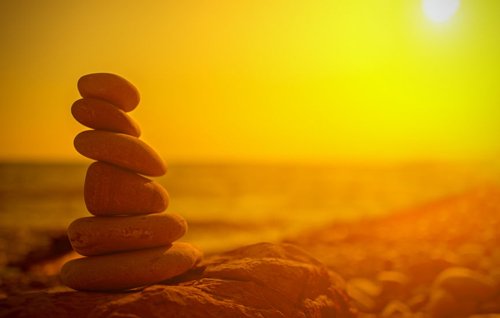 Stacking rocks at sunset honors the day and extends a blessing for a more peaceful tomorrow.